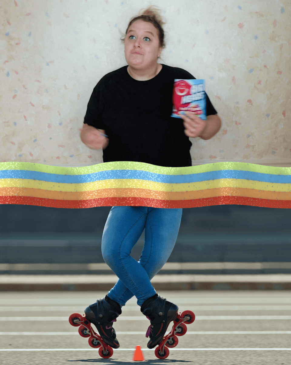 A person skating with a package of Airheads products in their hand.